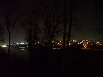 Illuminated street light in city at night