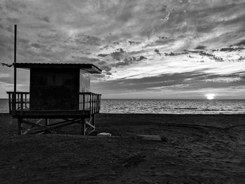 Built structure on beach against sky