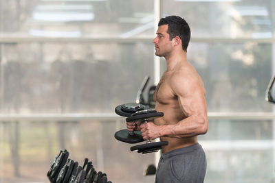 Muscular man exercising in gym