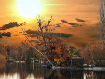 Scenic view of lake against orange sky