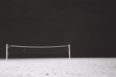 Empty chairs against wall during winter