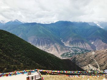 Prayer flags hanging against mountains during winter