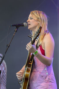 Young woman playing with umbrella at music concert