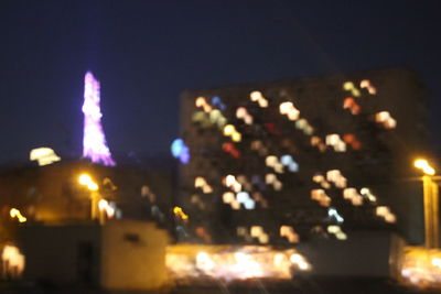 Close-up of lit candle at night