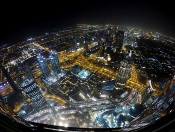 Aerial view of city lit up at night