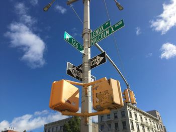 Low angle view of road sign against sky