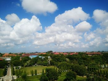 View of cityscape against cloudy sky