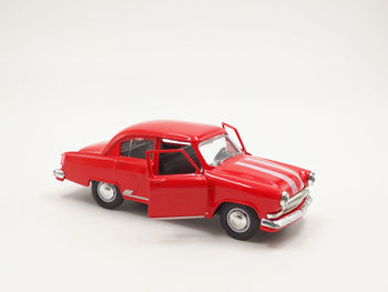 Red toy car against white background