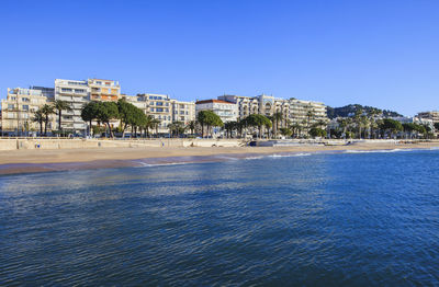 View of sea and residential district against clear sky