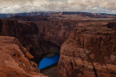 Scenic view of rock formations against cloudy sky