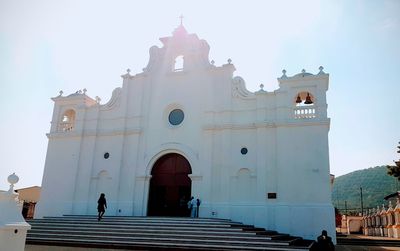 Low angle view of people walking at temple