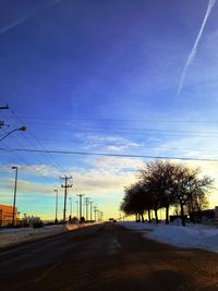 Empty road along trees