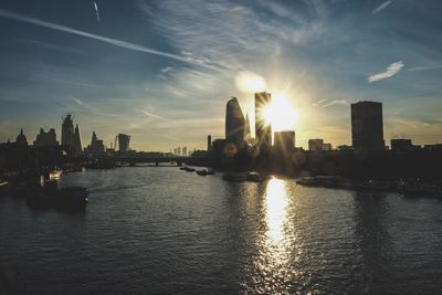 City buildings against sky during sunset