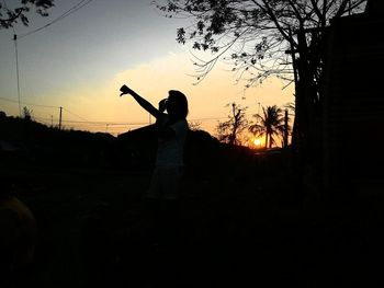 Low angle view of silhouette trees against sky at sunset