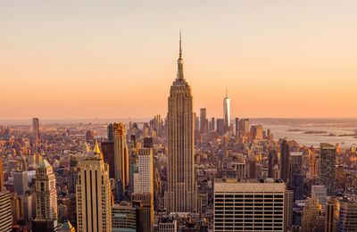 Aerial view of buildings in city during sunset