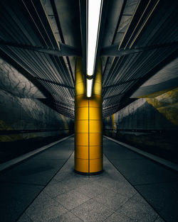 Empty illuminated railroad station platform