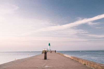 The small jetty and the green lighthouse in les sables d'olonne