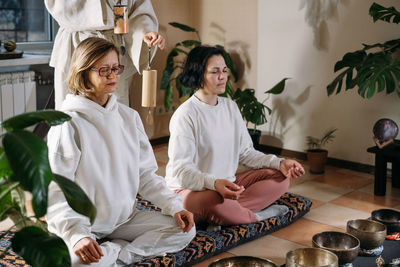 Portrait of female friends sitting at home