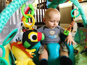 Close-up of cute baby sitting on toy