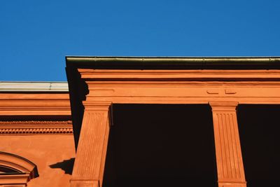 Low angle view of building against clear blue sky