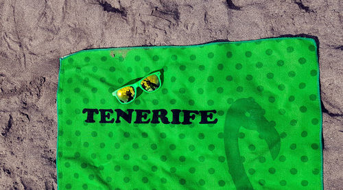 High angle view of text on green sign