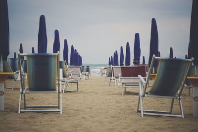 Chairs on empty beach 