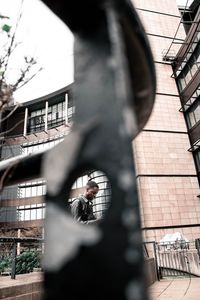 Woman standing by building