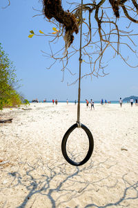 People on beach by sea against sky