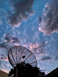 Low angle view of ferris wheel against building