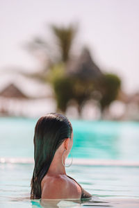 Rear view of woman in swimming pool