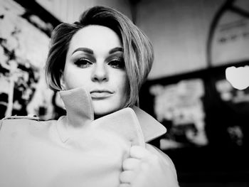 Portrait of young woman standing outdoors