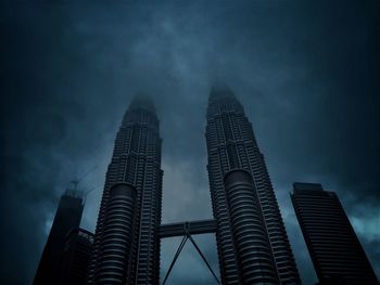 Low angle view of illuminated buildings against sky at night