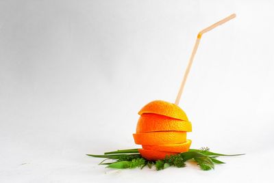 Close-up of orange fruit against white background