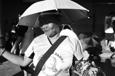 Vendor with umbrella used as hat with a beautiful smile