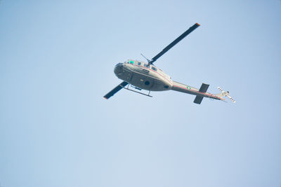 Low angle view of airplane against clear blue sky