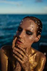 Portrait of a young woman with creative makeup