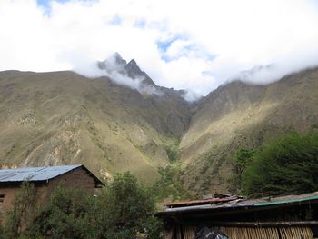 House on mountain against sky