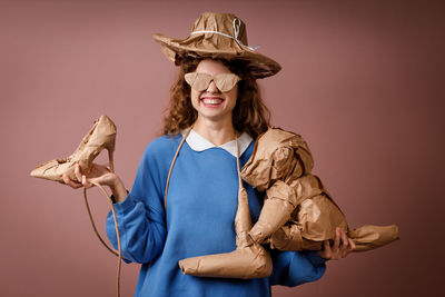 Portrait of woman wearing hat against wall