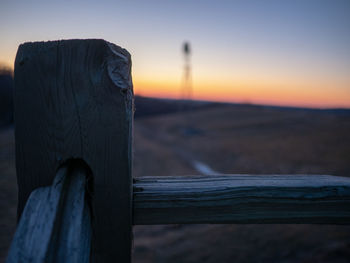 Close-up of wooden fence against sky during sunset