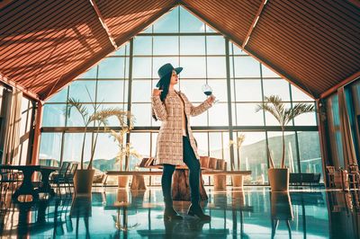 Woman standing by window in mexican vineyard