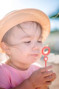 Close-up portrait of cute girl wearing hat