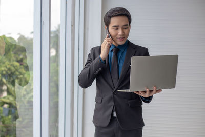 Mid adult man using mobile phone