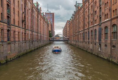 Canal amidst buildings in city