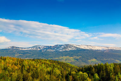 Scenic view of mountains against blue sky