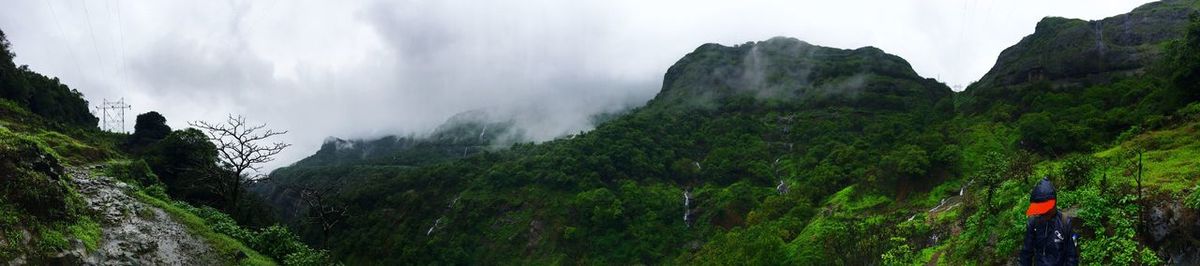 Scenic view of mountains against cloudy sky