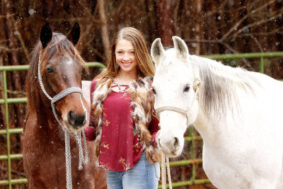 Portrait of young woman with horse
