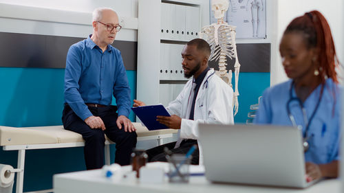 Doctor examining patient in office