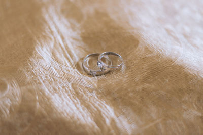 High angle view of wedding rings on table