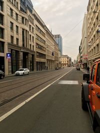 City street amidst buildings against sky