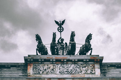 Statue against sky in city